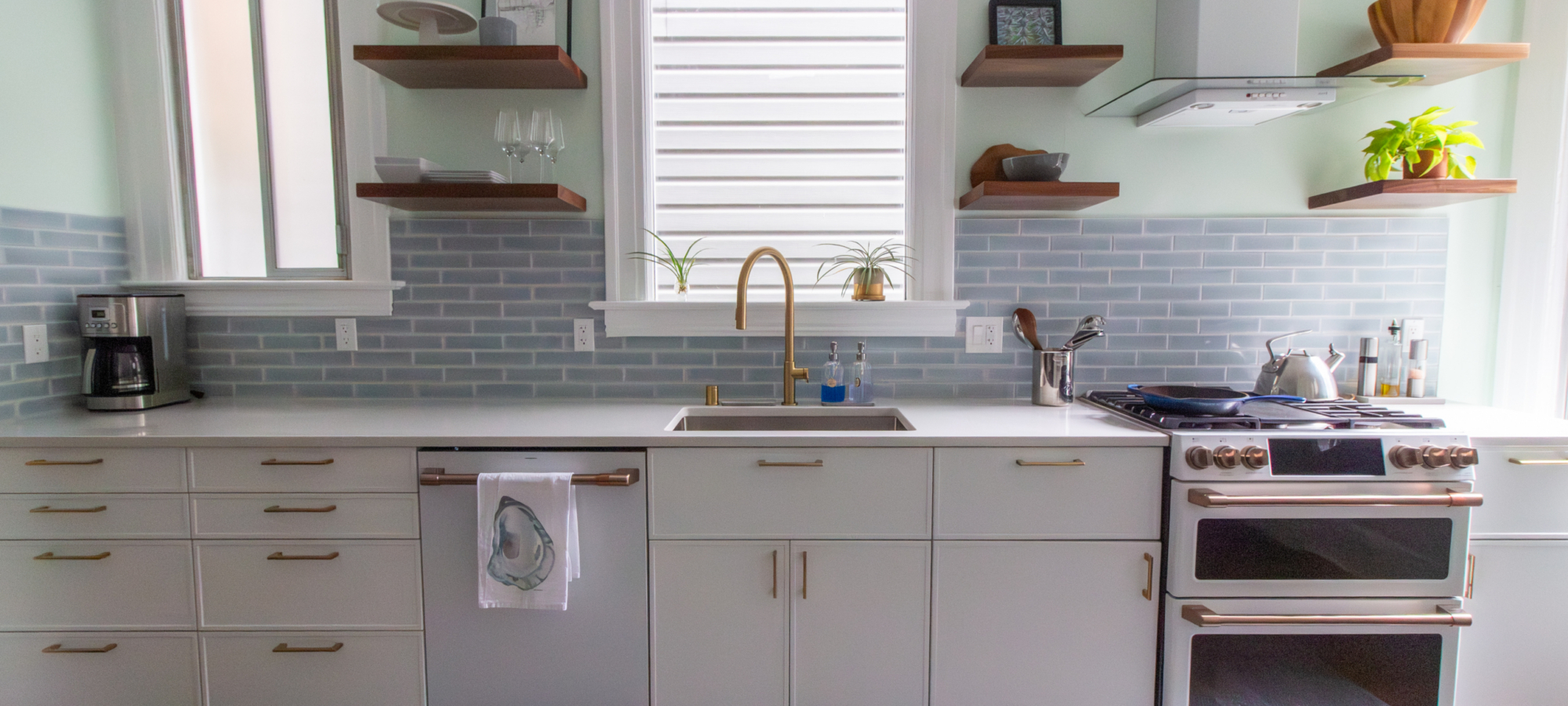 kitchen remodel with blue tile backsplash brass hardware